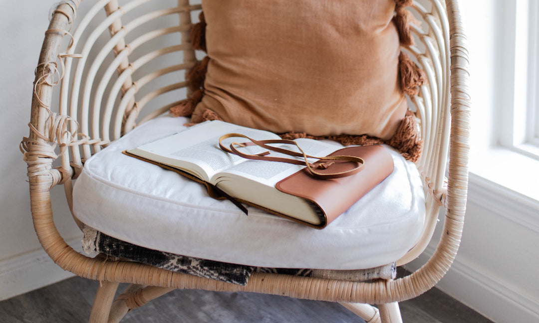 Bible and glasses on a chair.