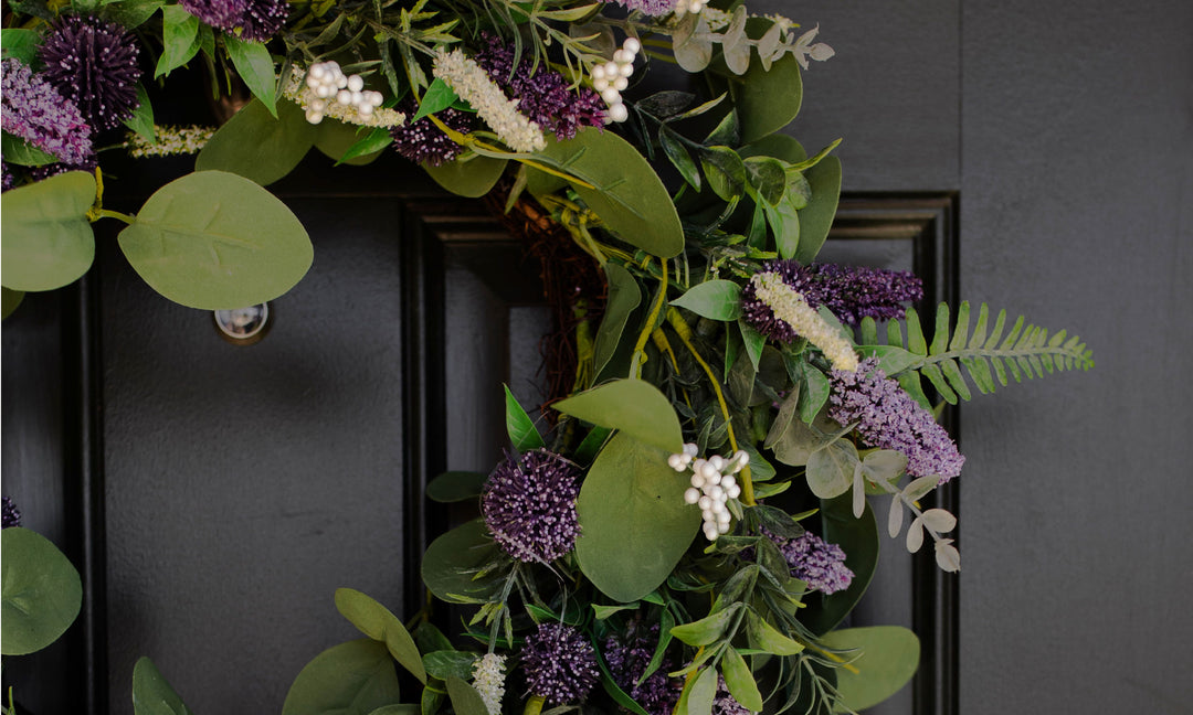 A wreath covered in flowers on a door