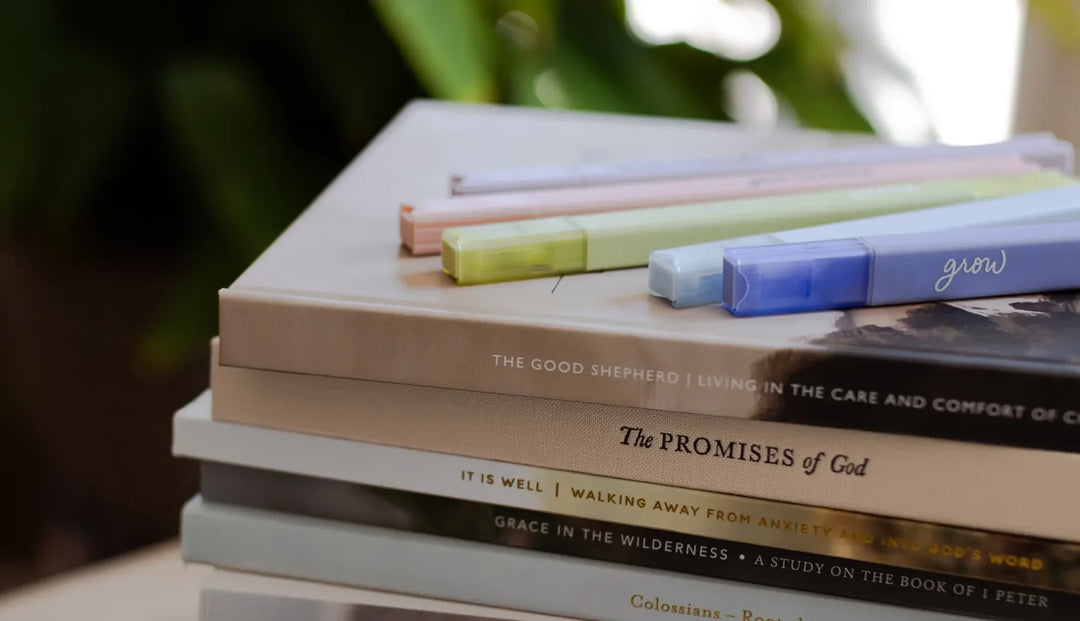 Multiple Daily Grace Highlighters on a stack of Daily Grace Bible Studies