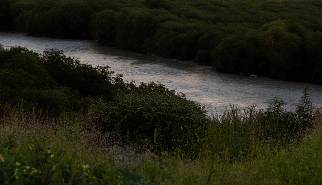 A lake going through two large areas of greenery