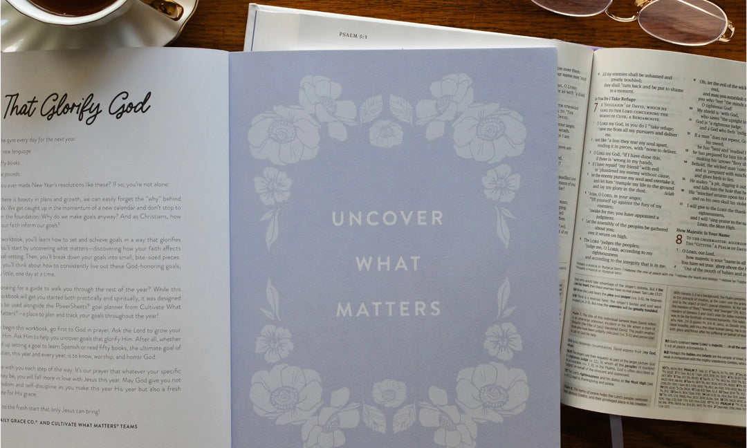 Uncover What Matters study laying on an open bible and next to another study on a wooden table