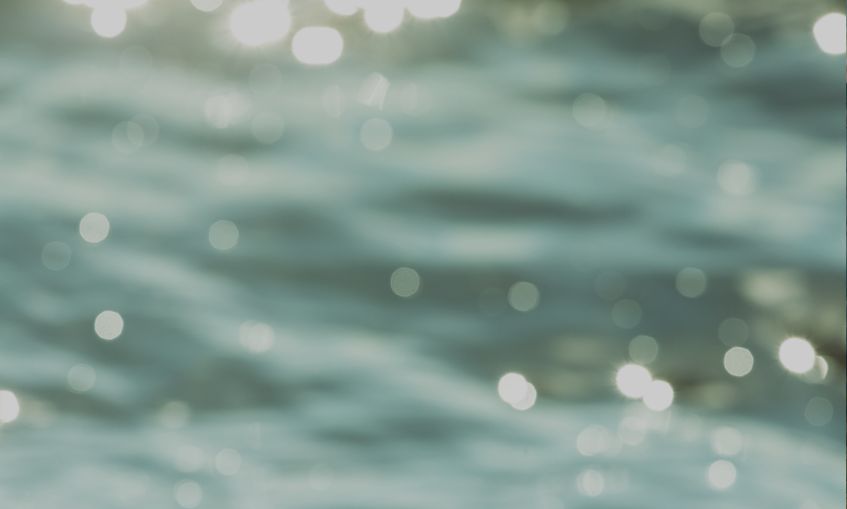 A blurry photo of water and shimmering lights