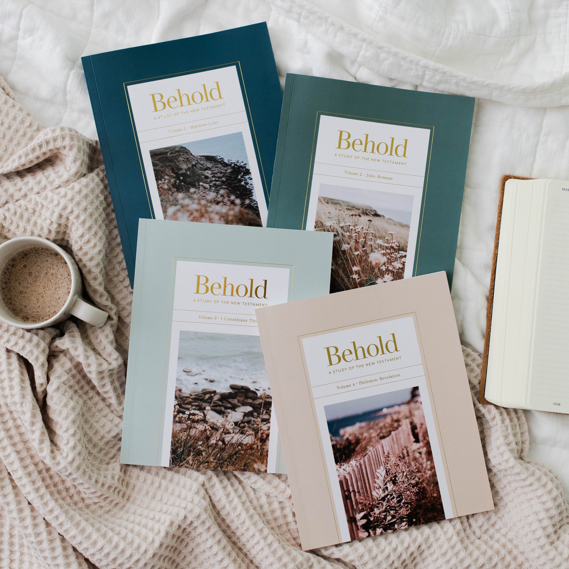 4 Bible studies on bed with mug of coffee.