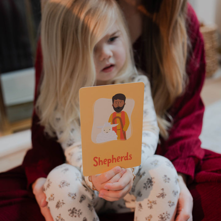 Little girl with mom reading Advent Card for Little Hearts