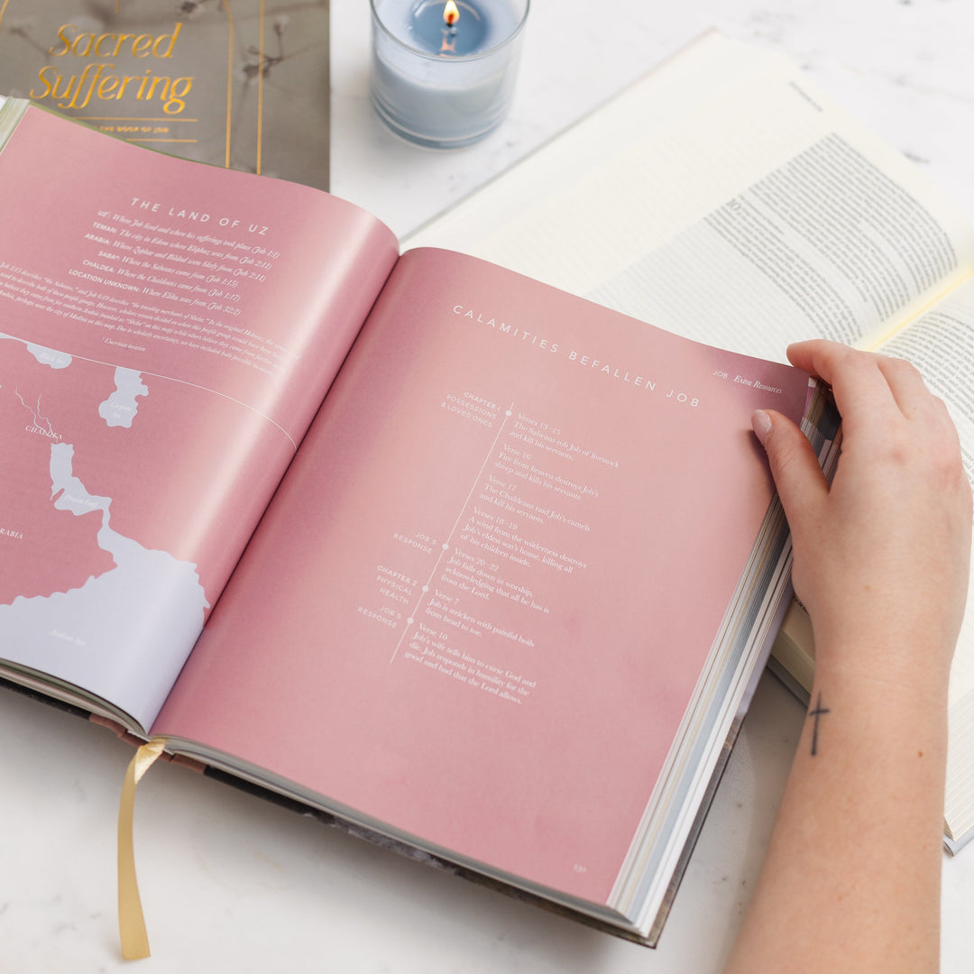 Woman looking through handbook opened to pages of maps