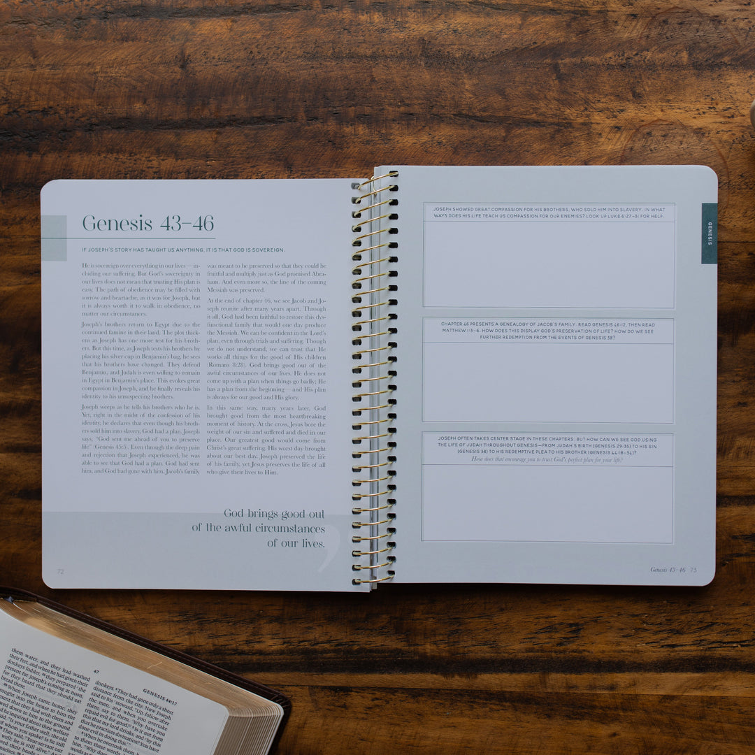 Eden to Eternity Volume 1 spiral opened to the questions and reflections page on a wooden table next an open bible