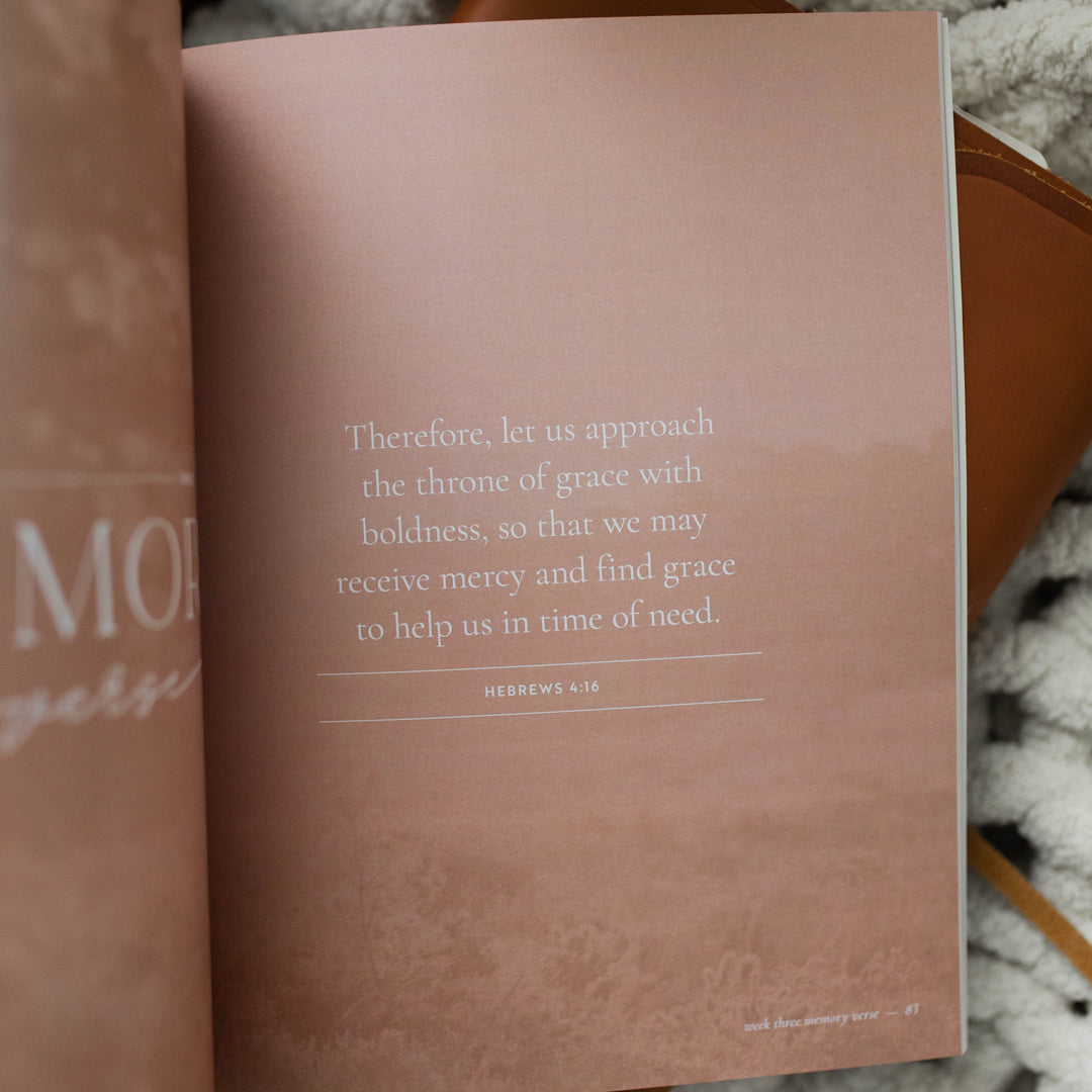 It Is Well Study opened to page 83 memory verse; The Study is laying on a leather book and a white knitted blanket