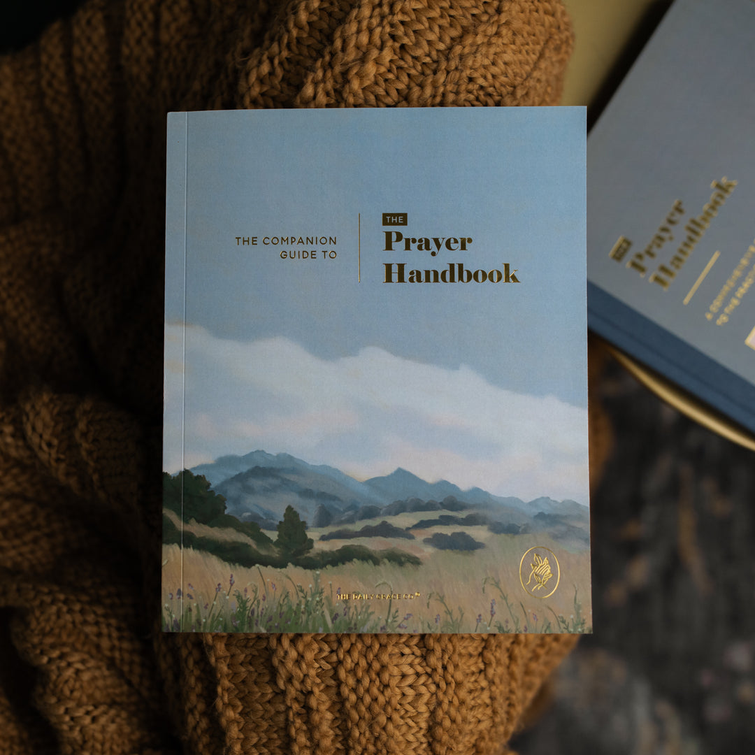 The Companion Guide to The Prayer Handbook cover on a brown knitted blanket