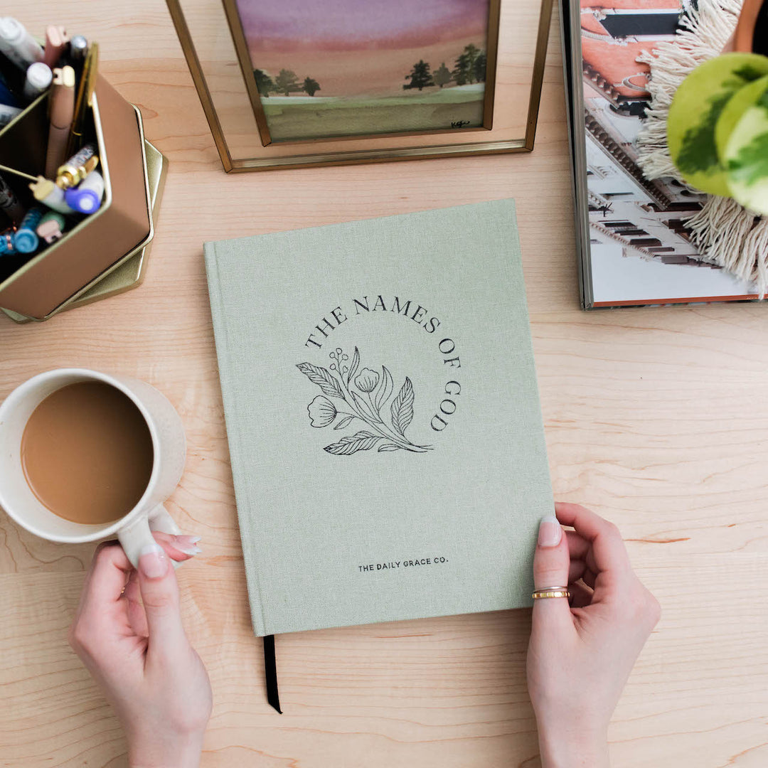 Coffee table book next to photos and coffee mug