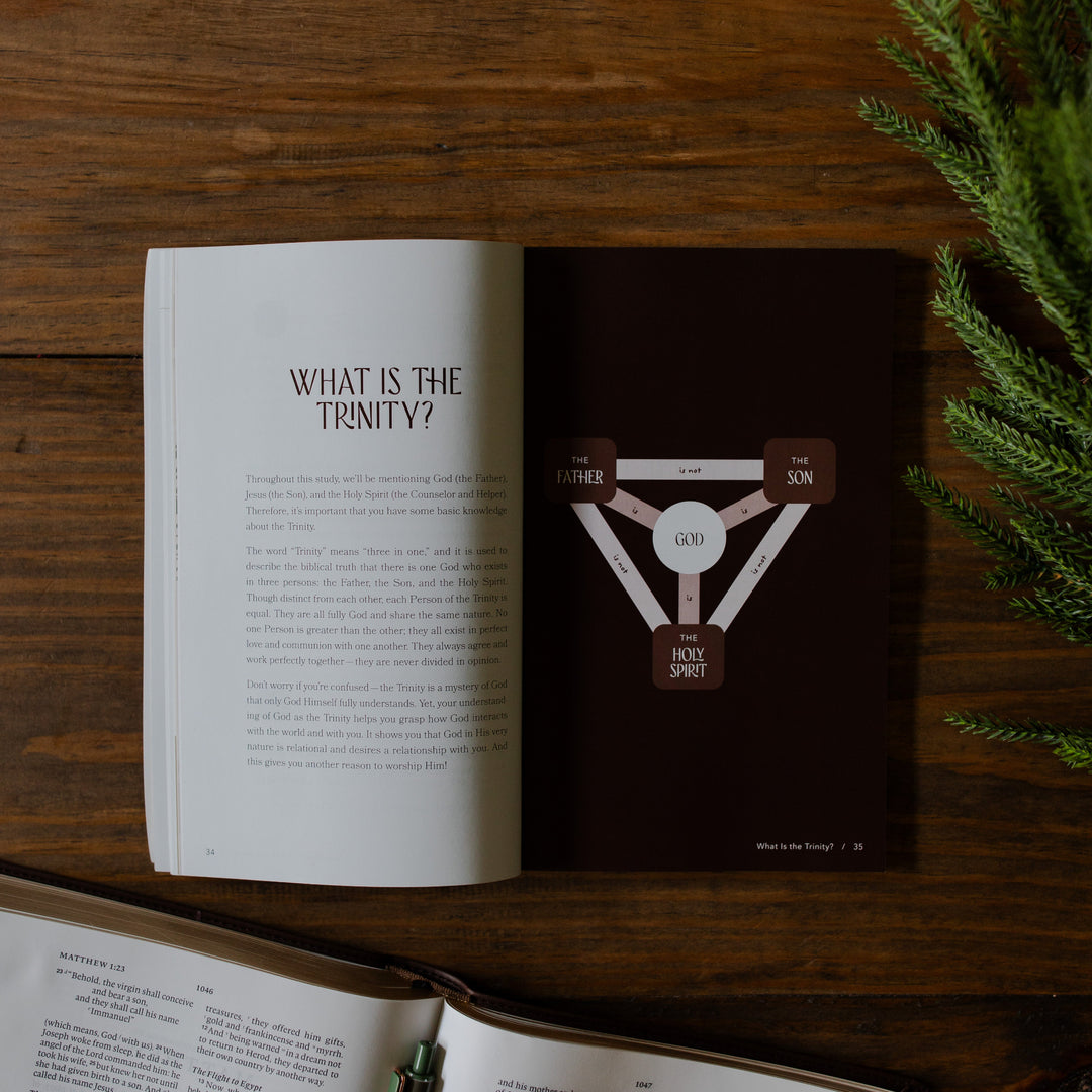 With you Always Teen Advent Study opened to the What is the Trinity page on a wooden table next to some greenery