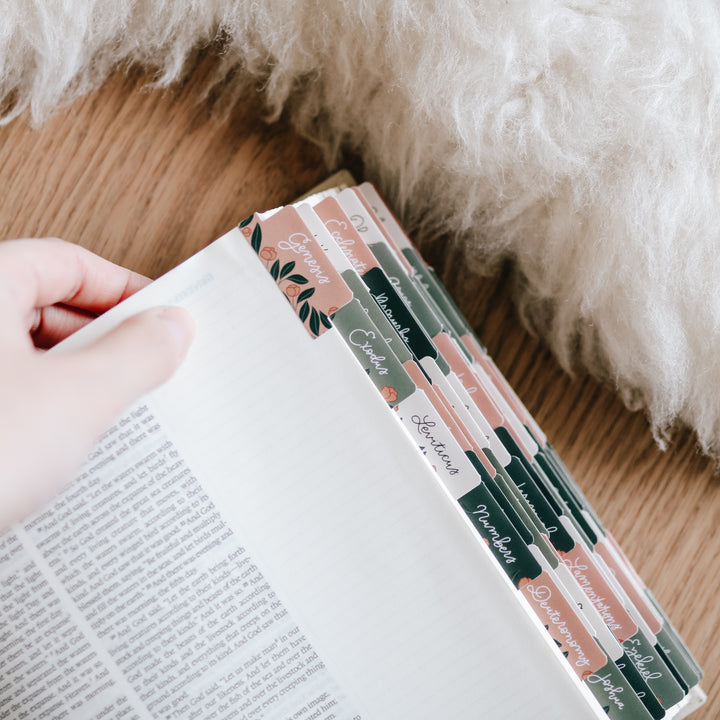 woman holding journaling bible displaying floral bible tabs for women