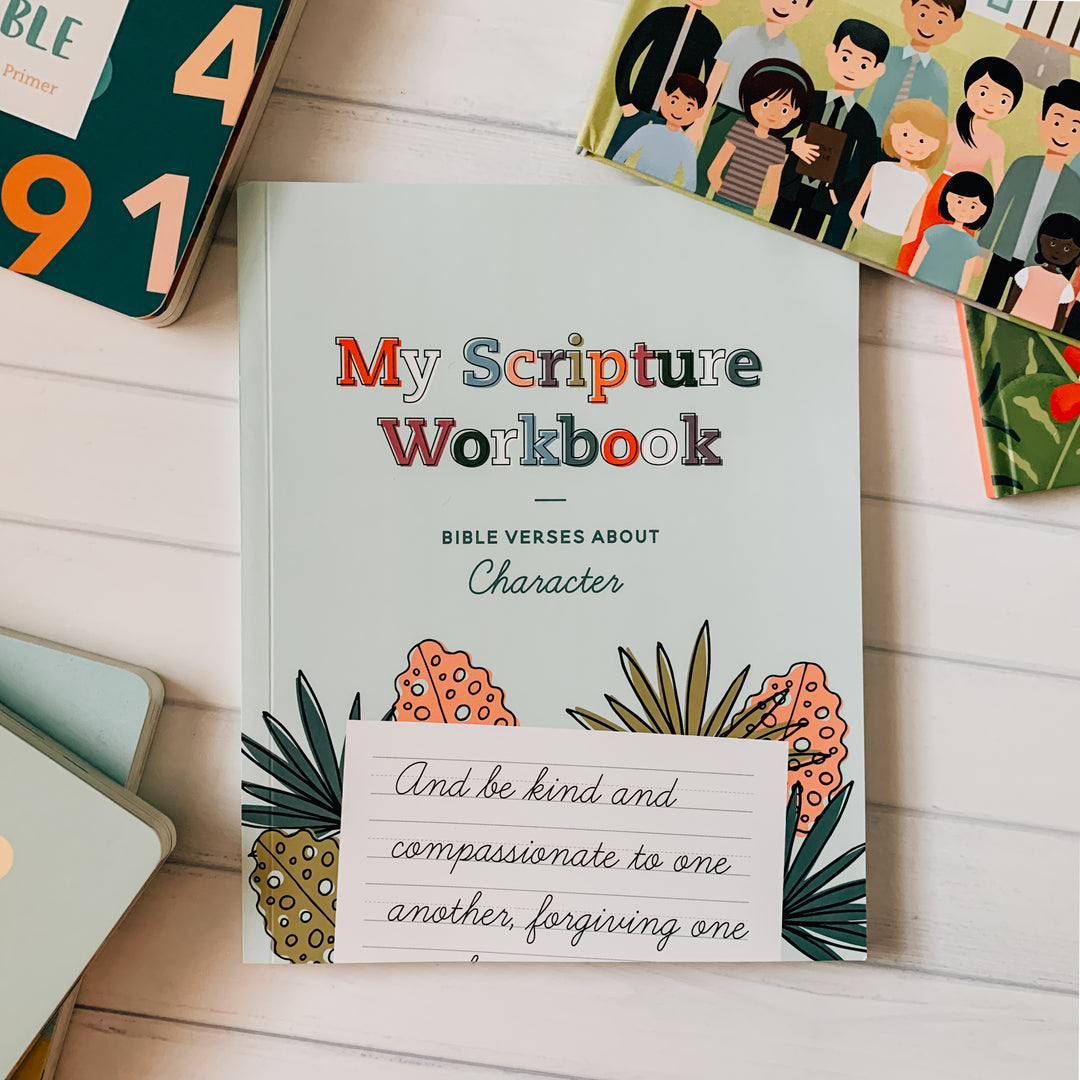 My Scripture Workbook: Bible Verses about Character is laying on a table surrounded by other Daily Grace children books.