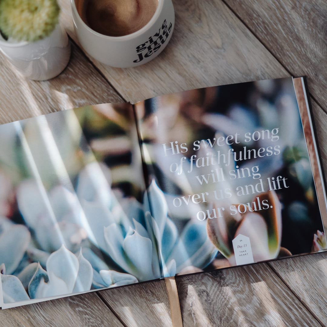 Devotional book opened to a page with writing and pictures