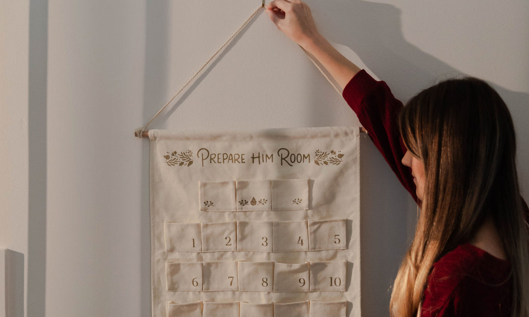 Woman hanging decor on the wall