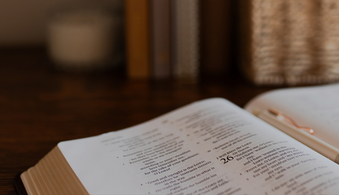Closeup of an open bible on a wooden table