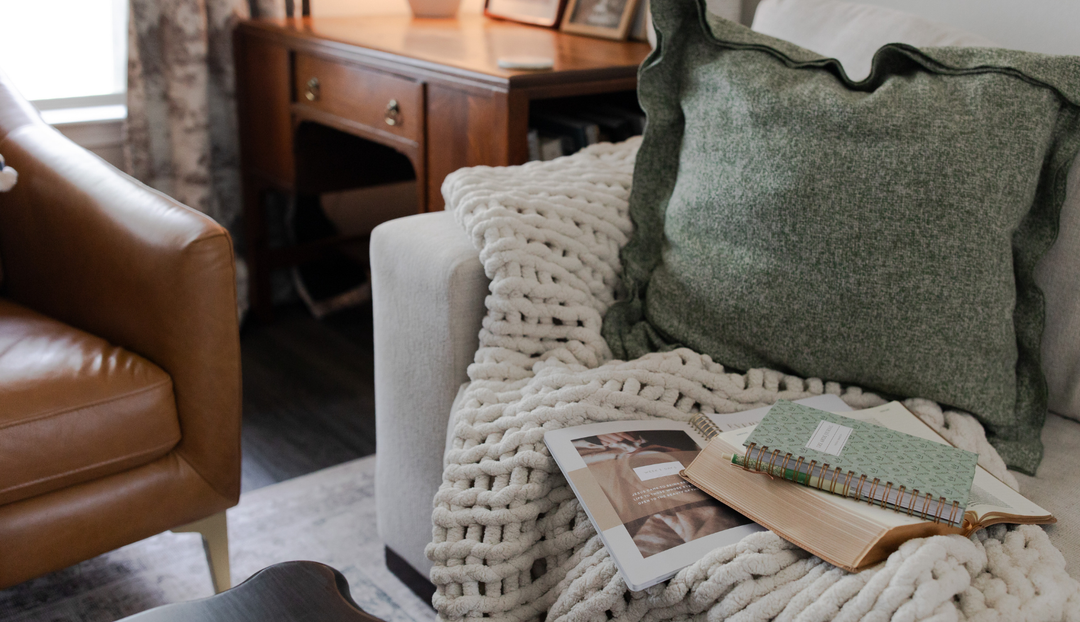 A group of Daily Grace products on a white couch near a leather couch