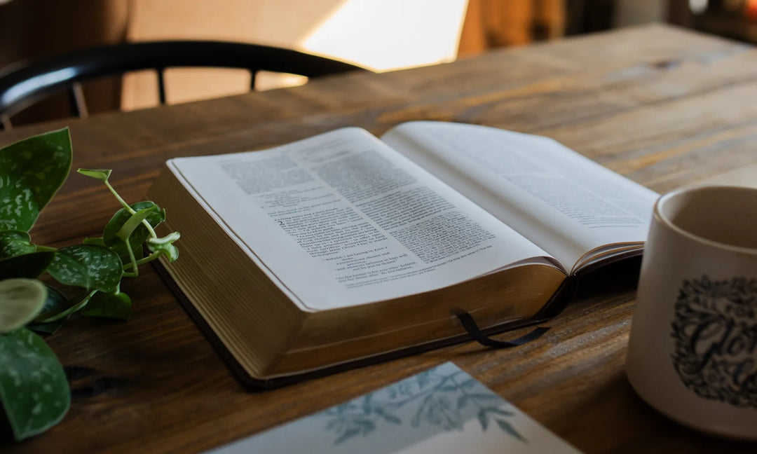 A Bible opened on a wooden table