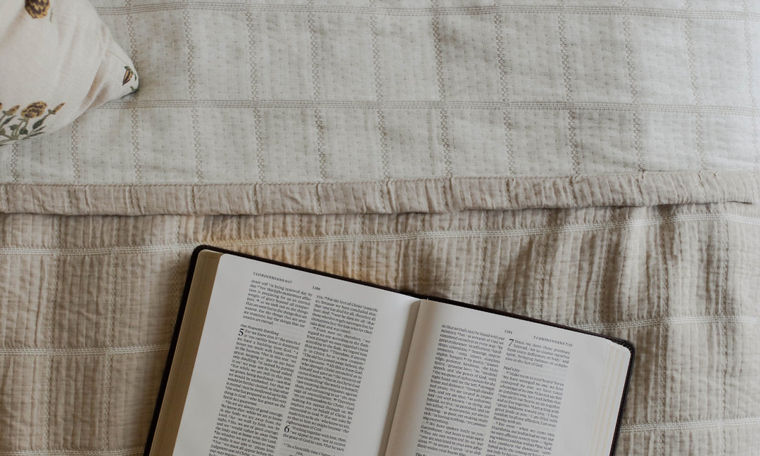 Open Bible on a bed