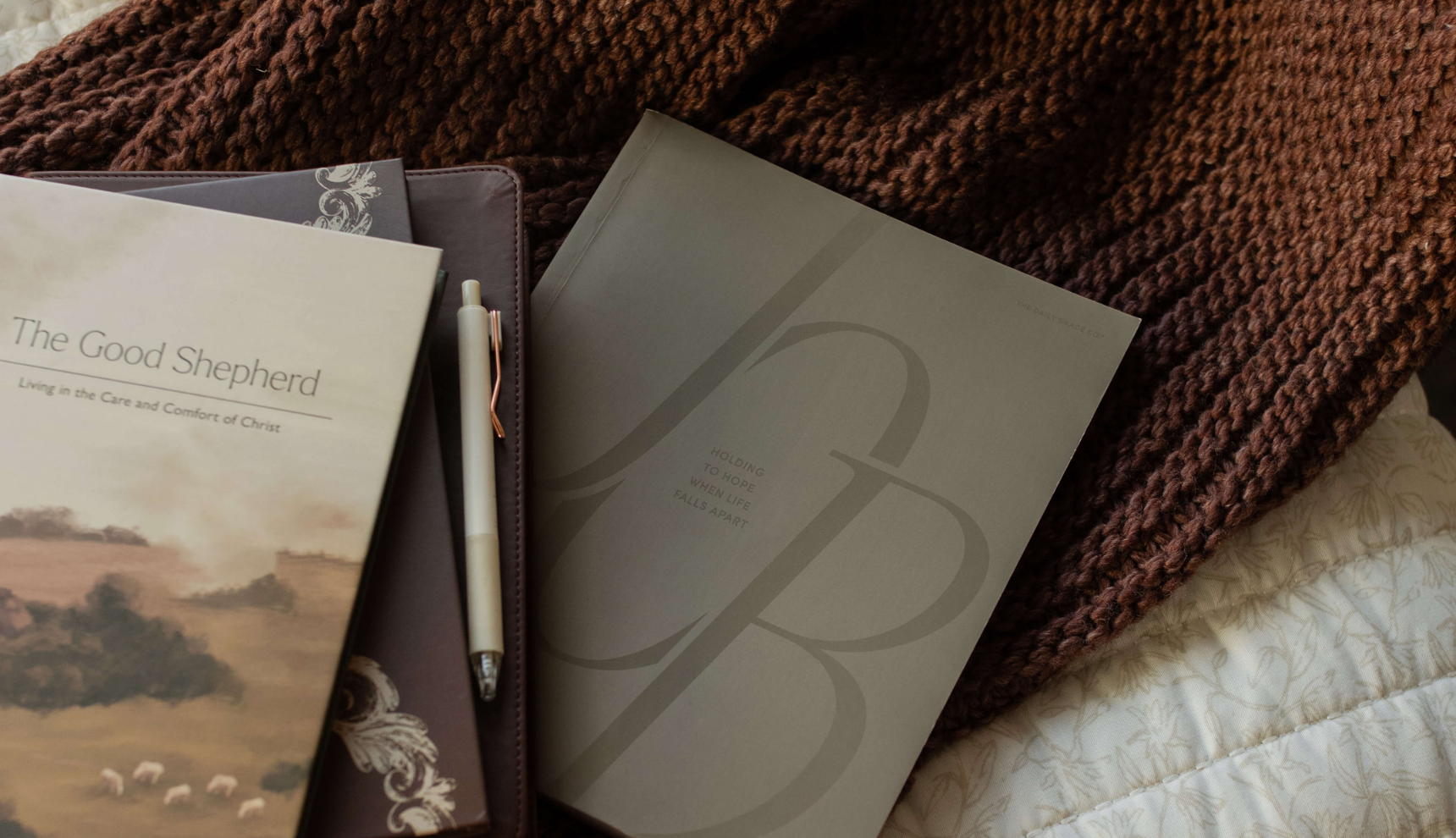 The Job study near some other Daily Grace products on a brown woven blanket