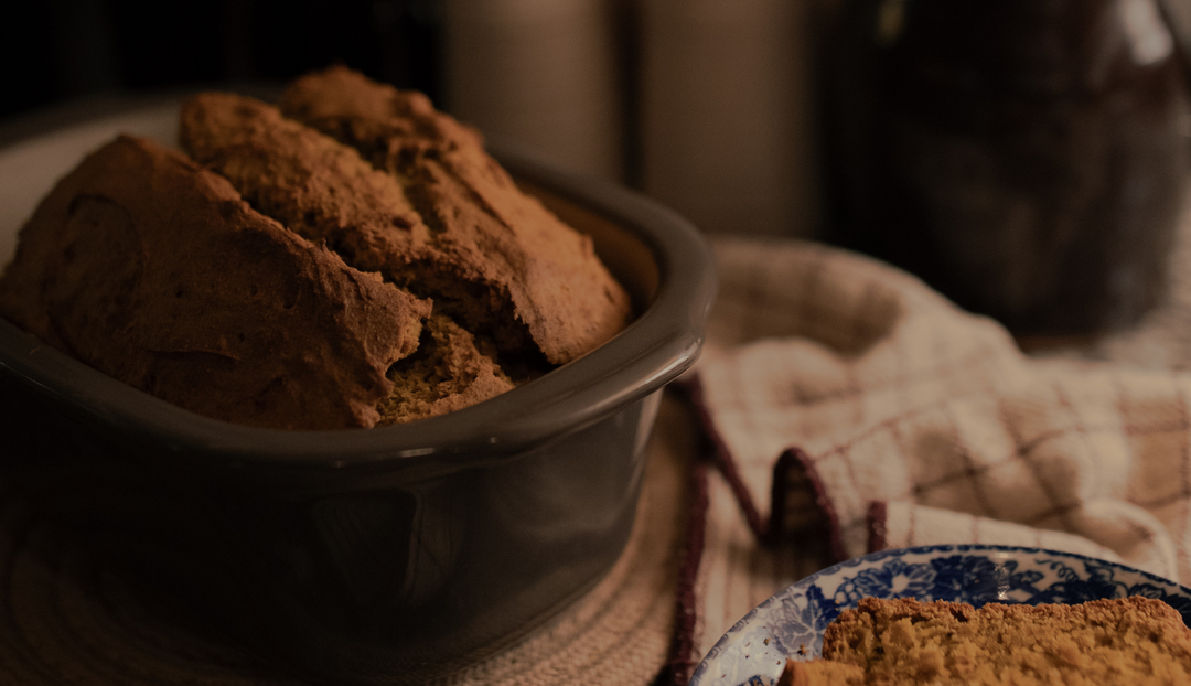 A bowl of bread near some dish rags