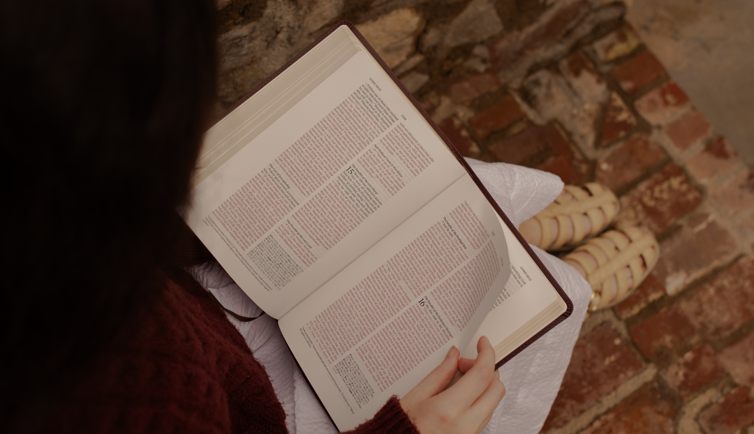 A woman reading from an open bible