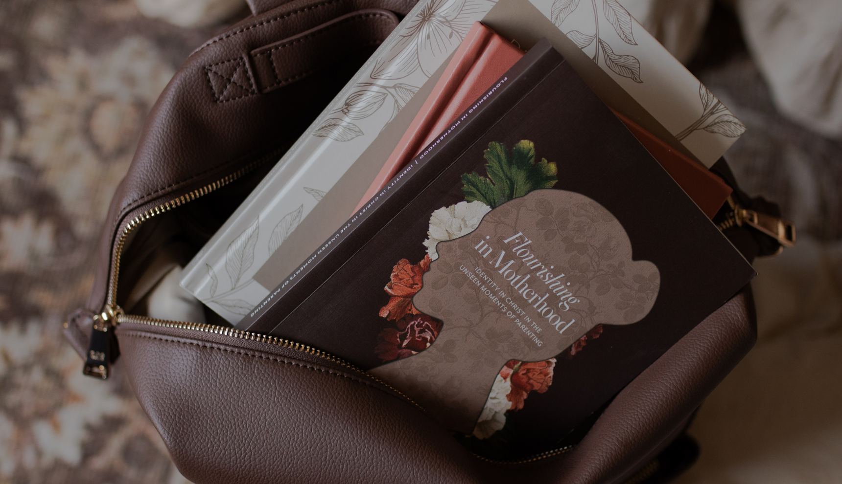 The Flourishing in Motherhood book and other studies in a book bag