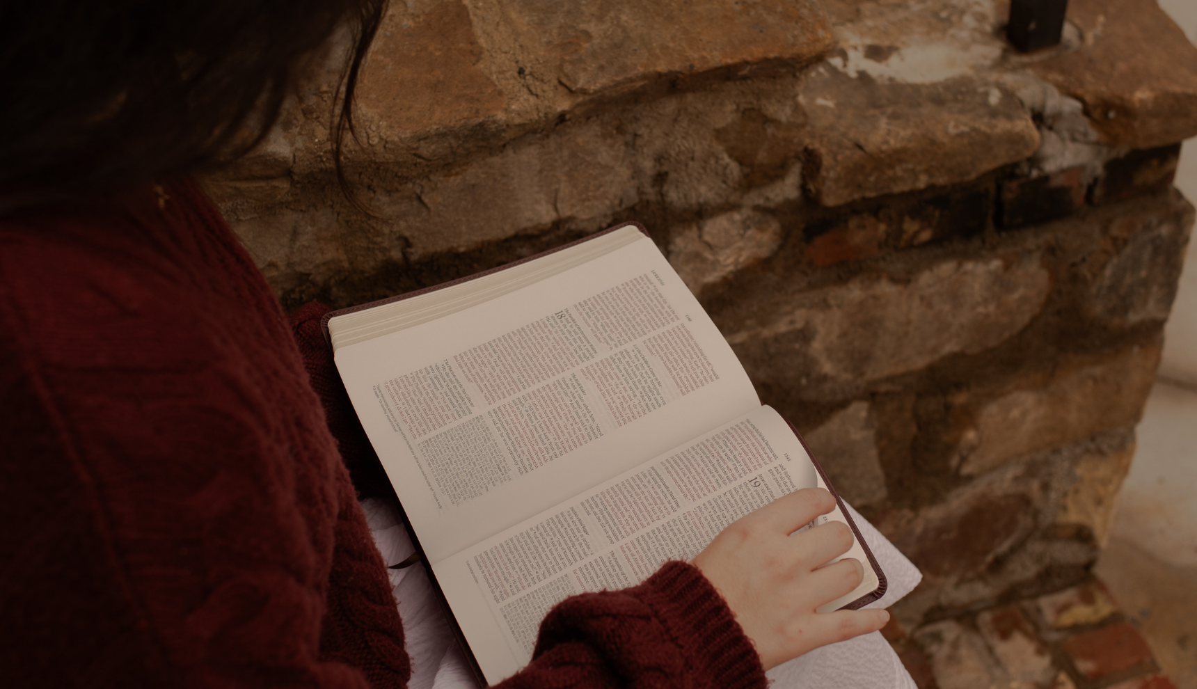 A woman reading from an open bible