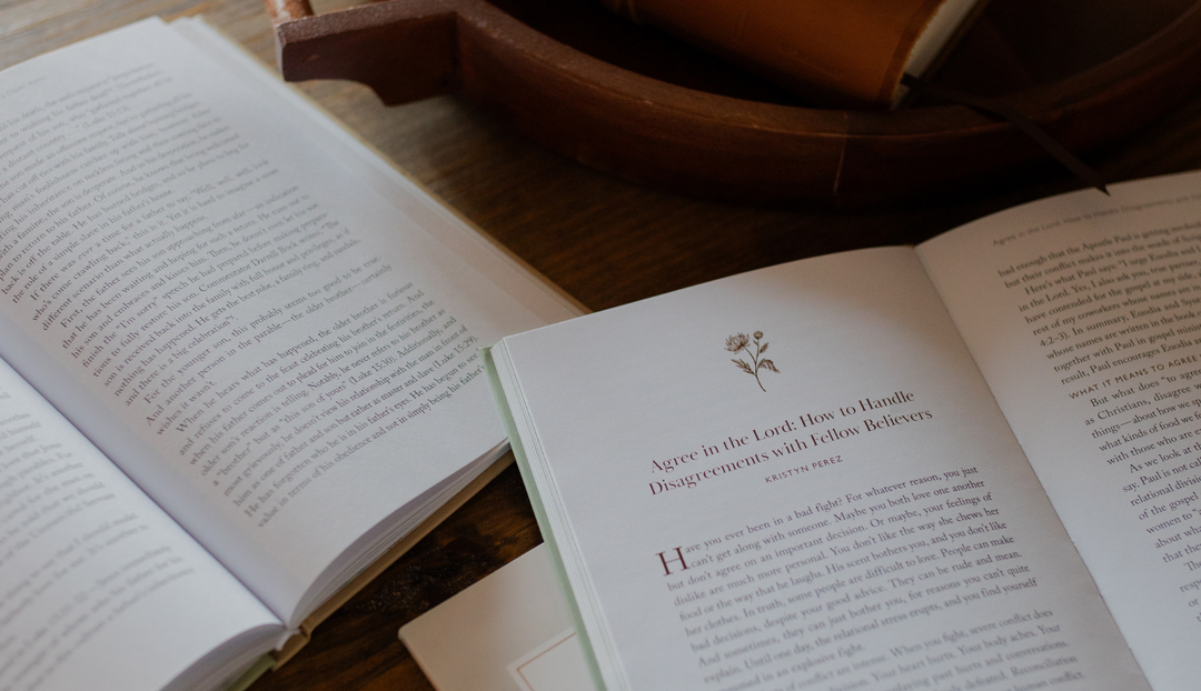 Two open studies on a wooden table near some wooden decor