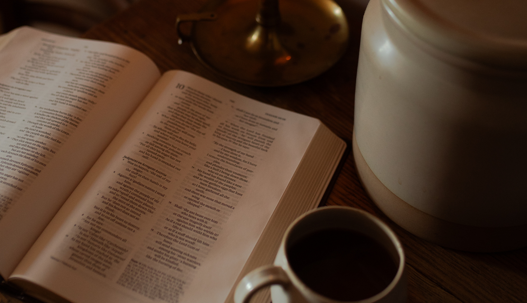 An open bible near a cup of coffee