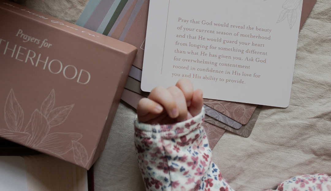 A child's hand on some motherhood verse cards