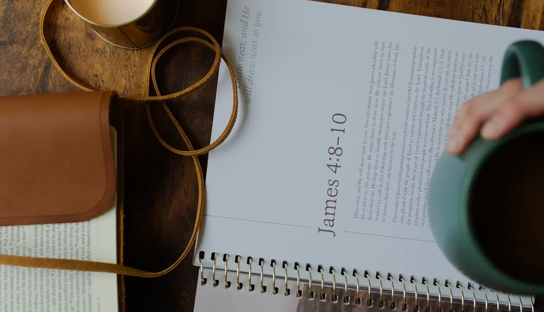 An open bible study opened to James 4:8-10 with an open bible nearby and a green coffee cup