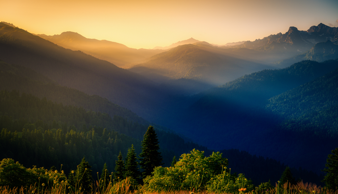 An overlooking landscape with a sunset in the distance
