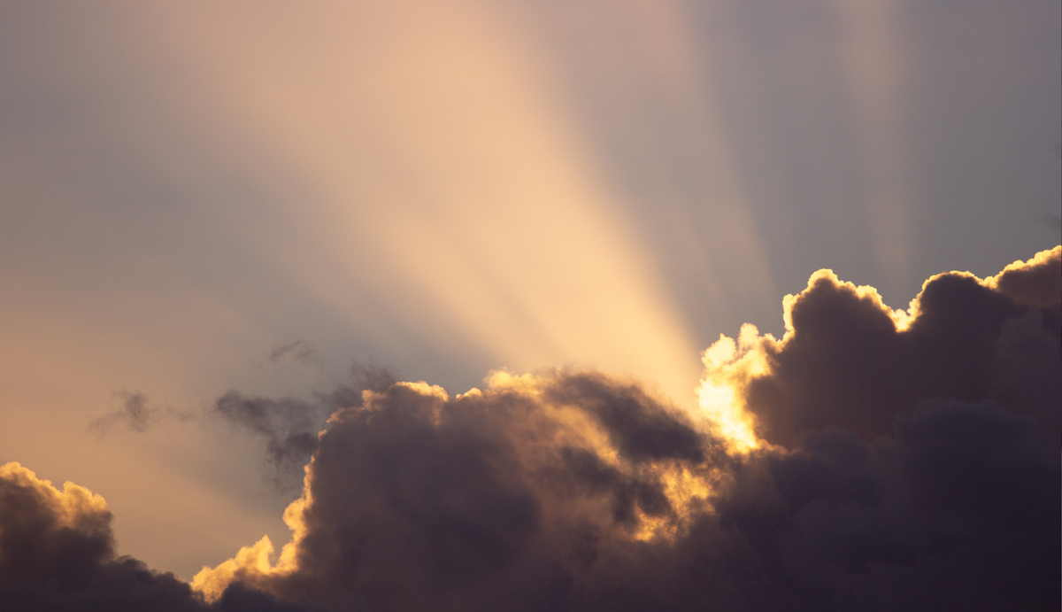 The sun rising over the clouds