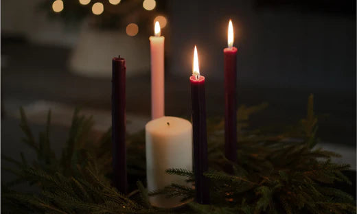 Candle lit around a smaller unlit candle