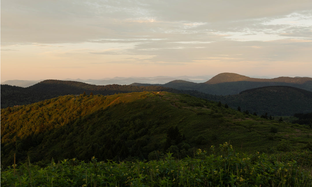 A view of the mountains and the horizon during sunrise