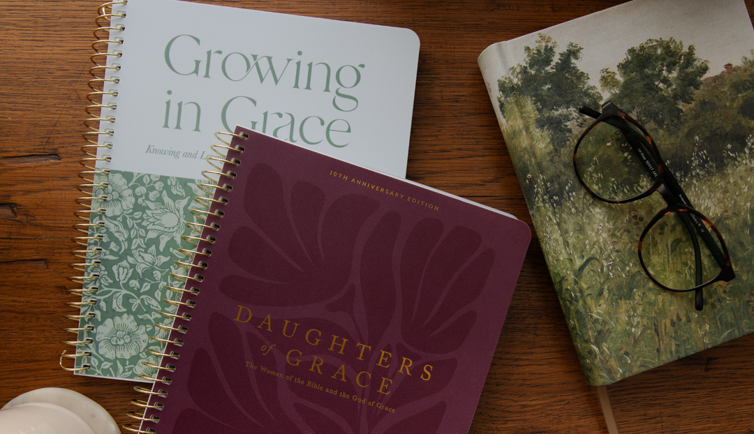 Multiple New Daily Grace Bible studies on a wooden table