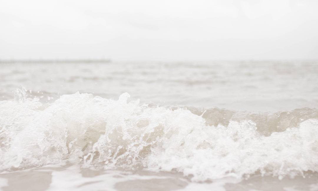 Gray waves washing up onto the shoreline