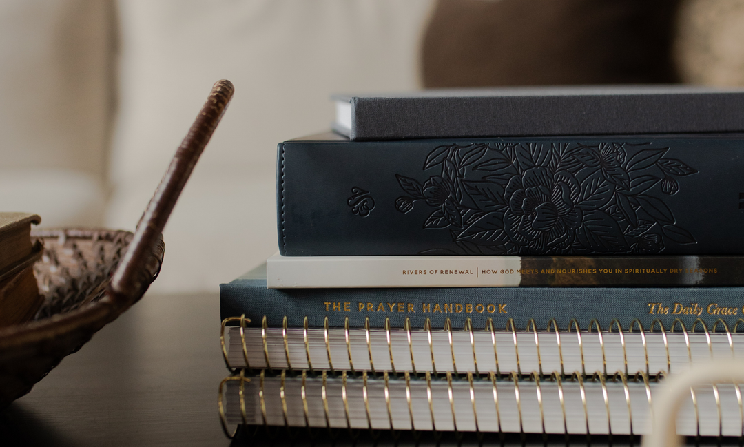 A stack of Daily Grace products next to a wicket basket handle