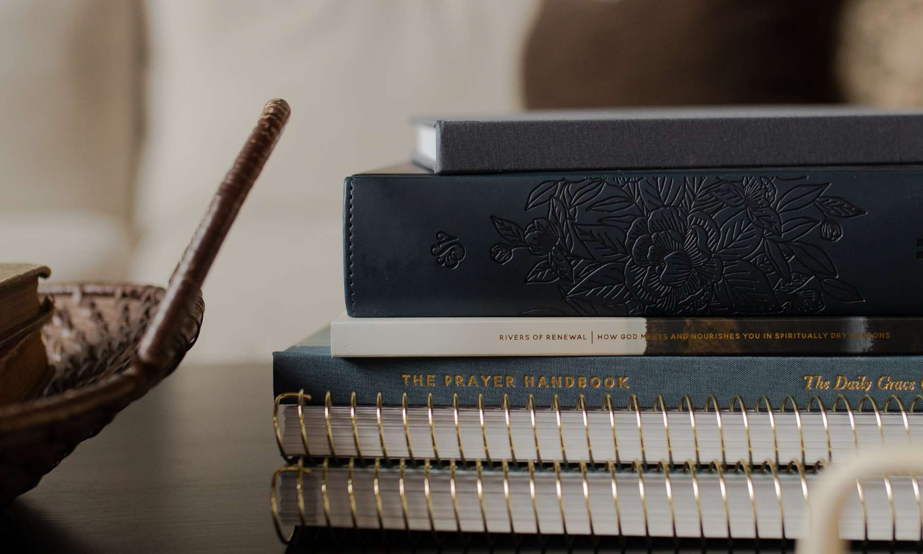 A stack of Daily Grace products next to a wicket basket handle