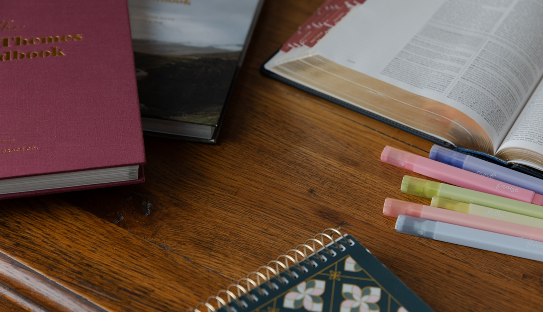 Multiple daily grace studies and accessories on a wooden table