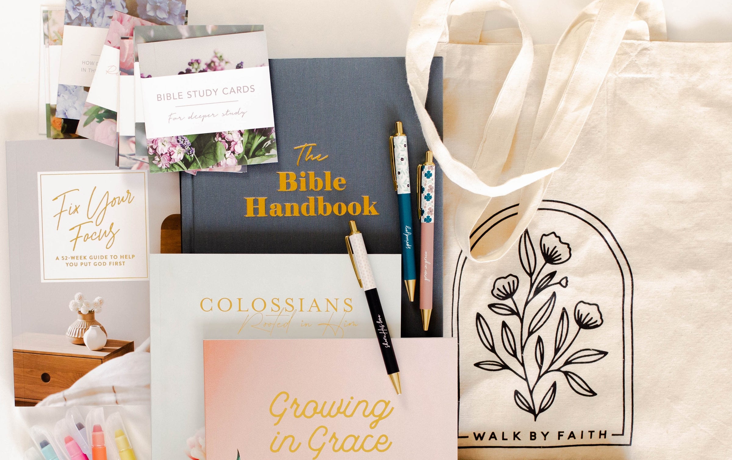 Tote bag with Bible studies and pens on floor