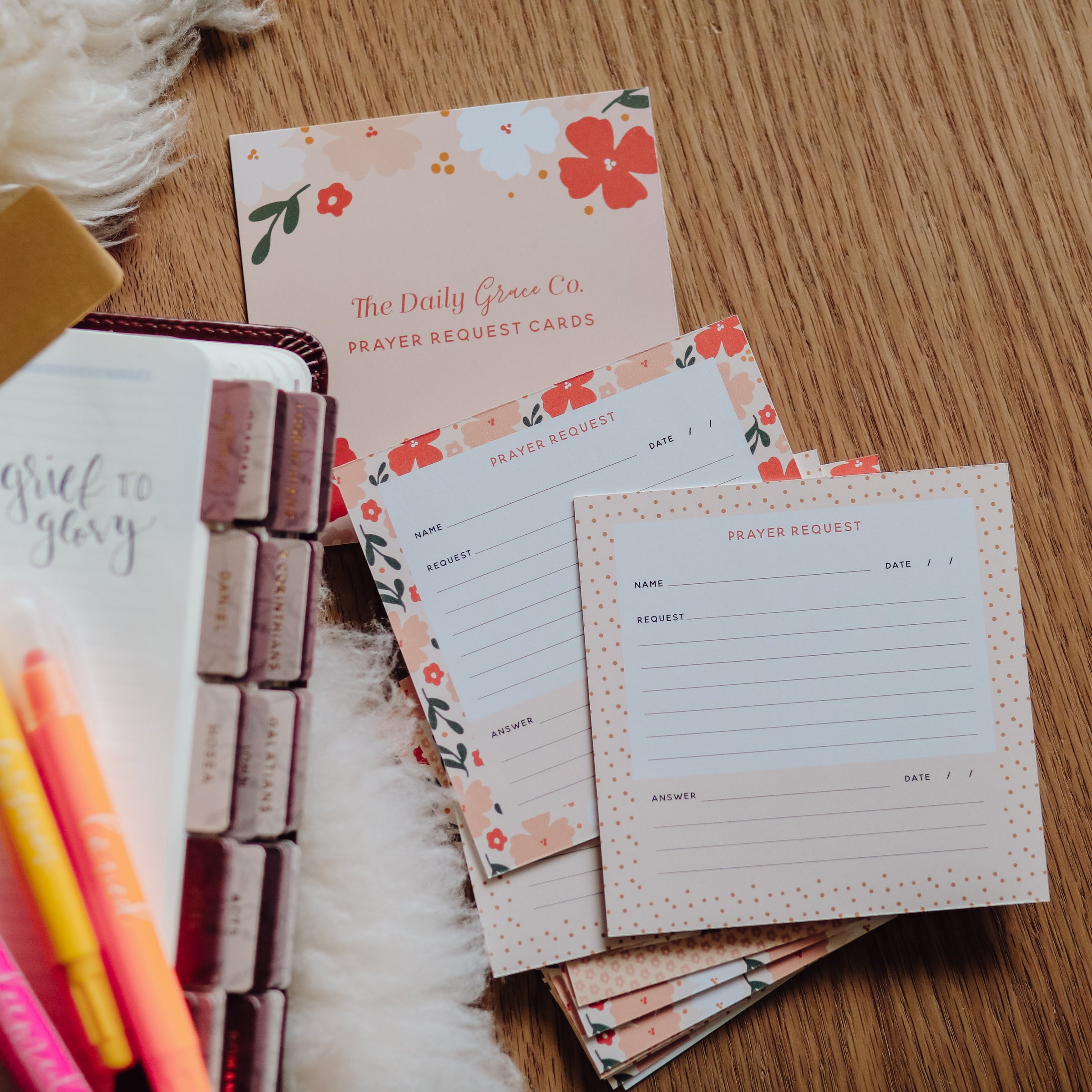 Bible, Bible tabs, highlighters, and scripture memory cards on wood floor.