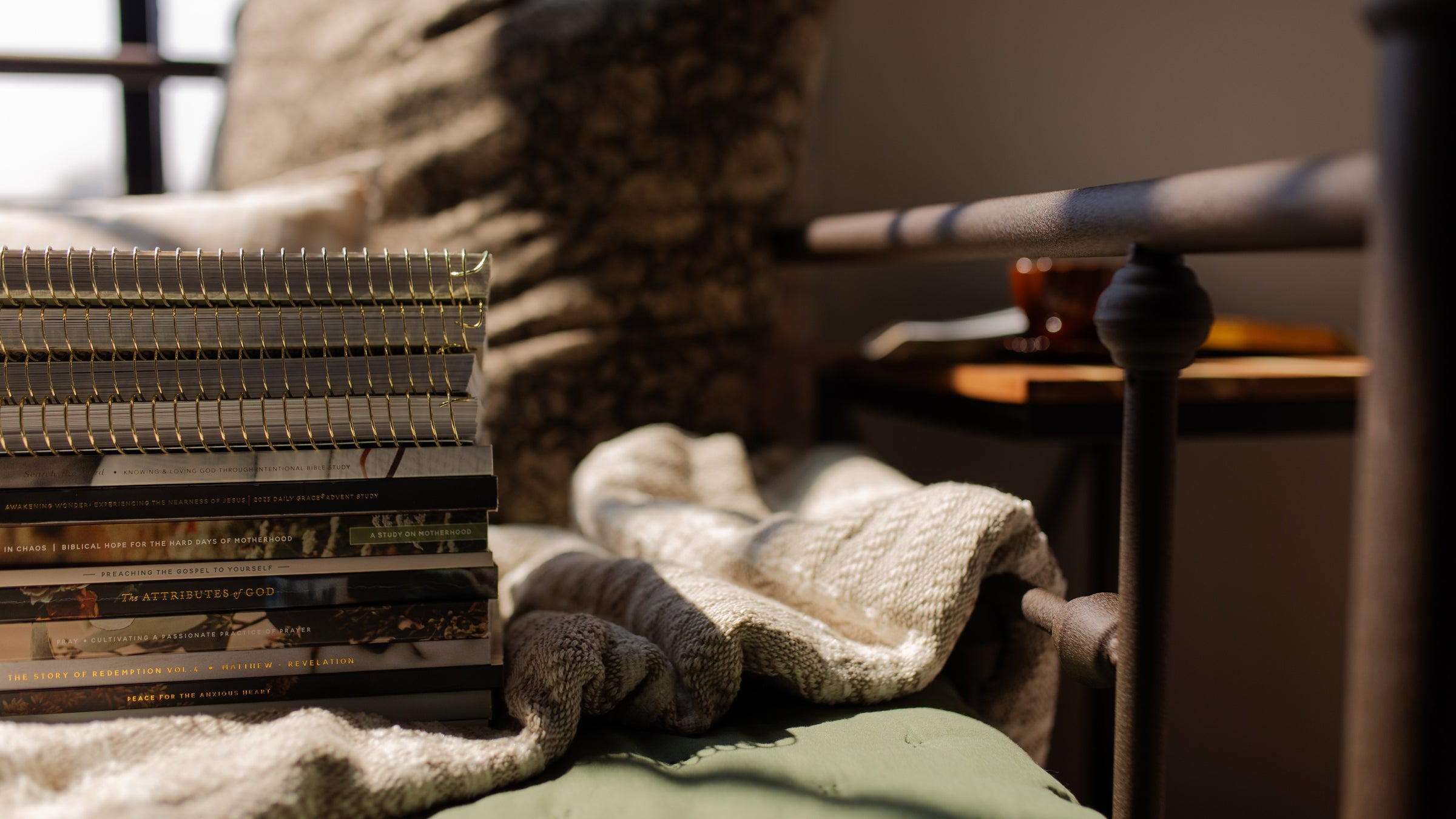 Stacks of multiple Daily Grace studies on a blanket and a green mattress