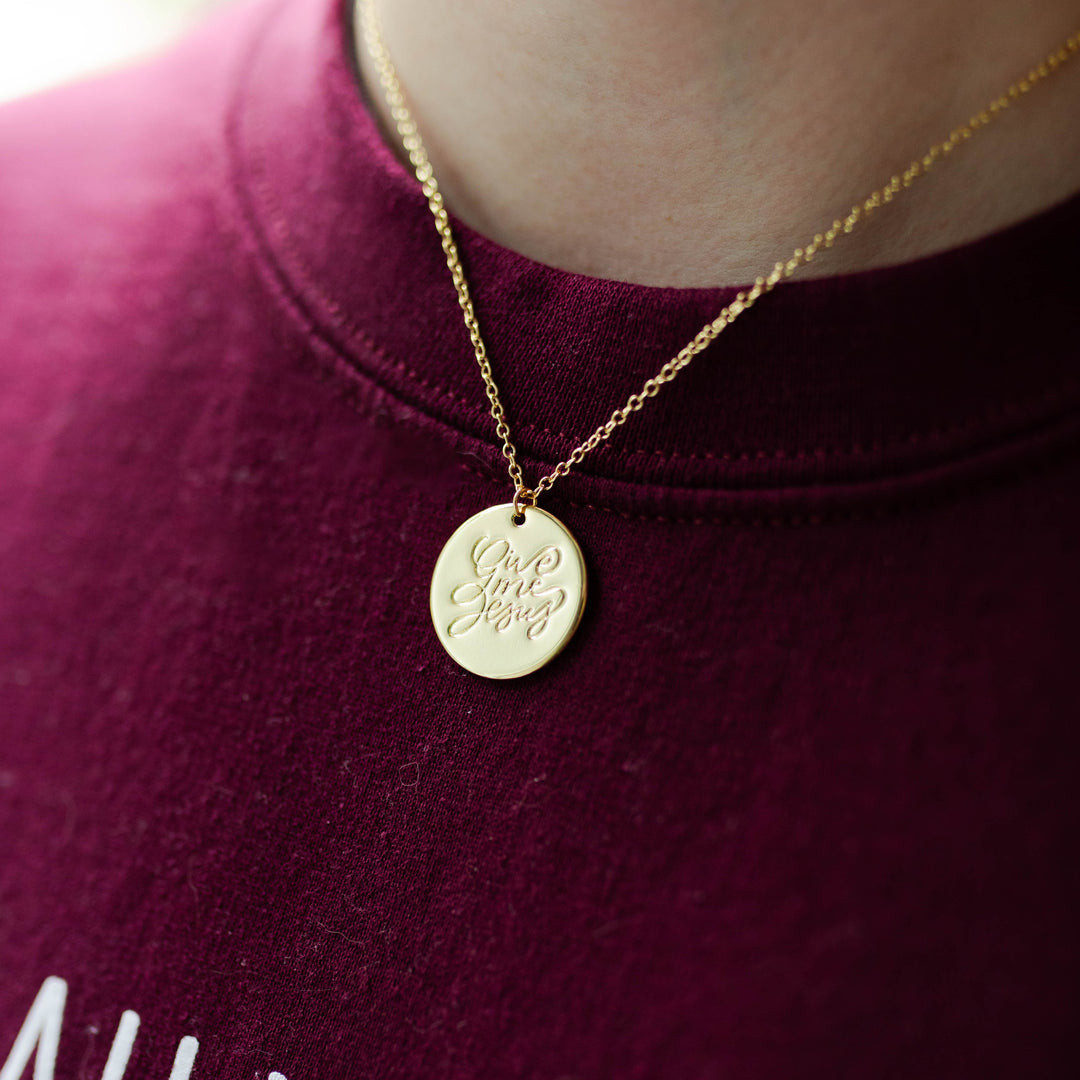 Christian Necklace displayed on maroon shirt