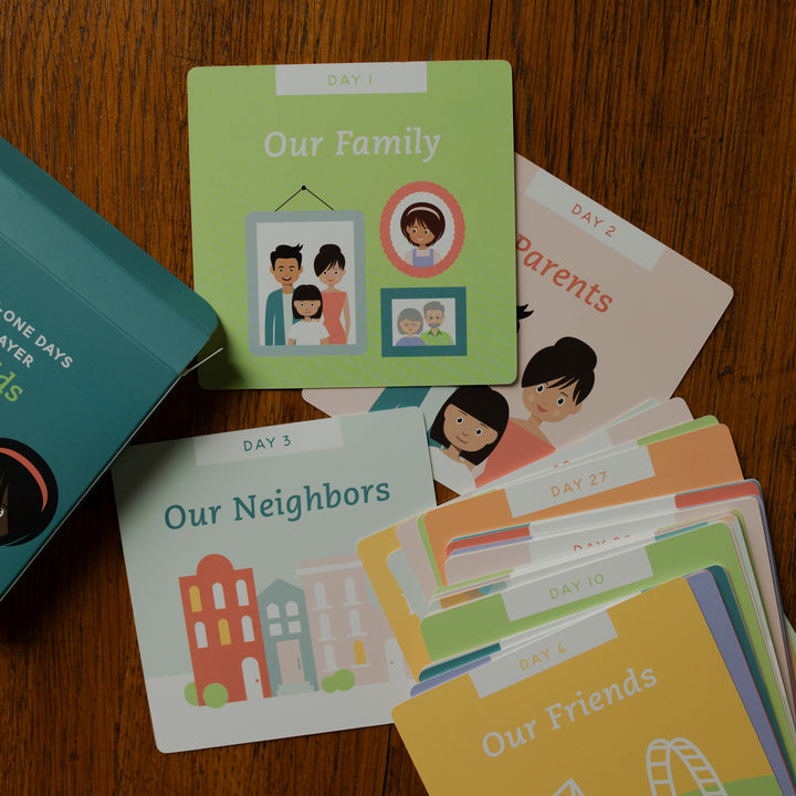 The 31 Days of Prayer for Kids Verse Cards scattered on a wooden table