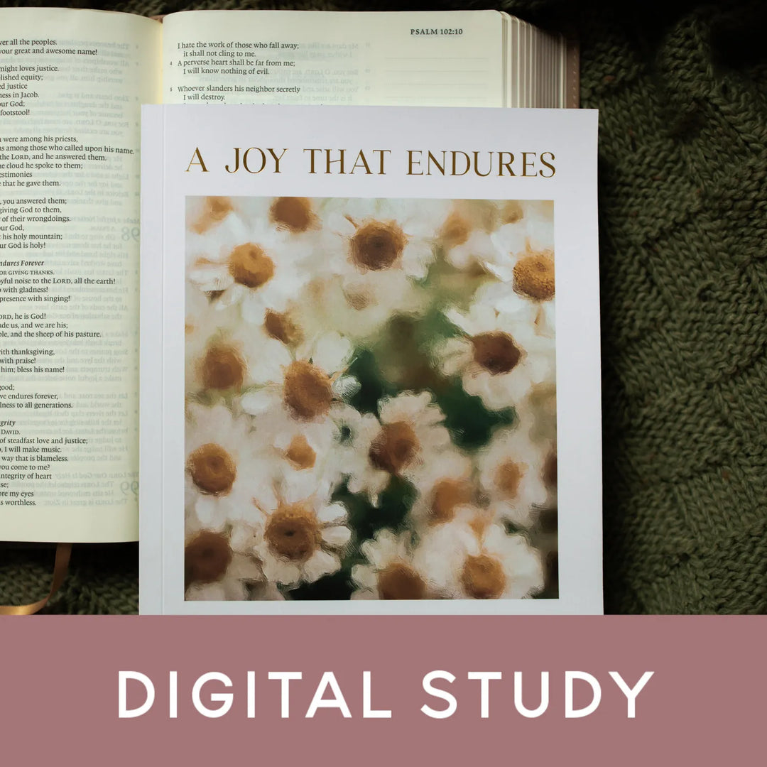 A Joy that endures on an open bible laying on a green cross knitted blanket