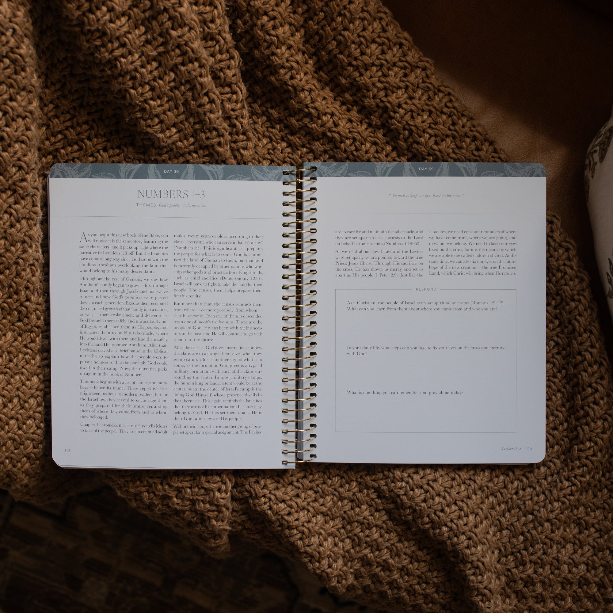 A Year in the Bible spiral opened to the Numbers content and response page on a brown knitted blanket