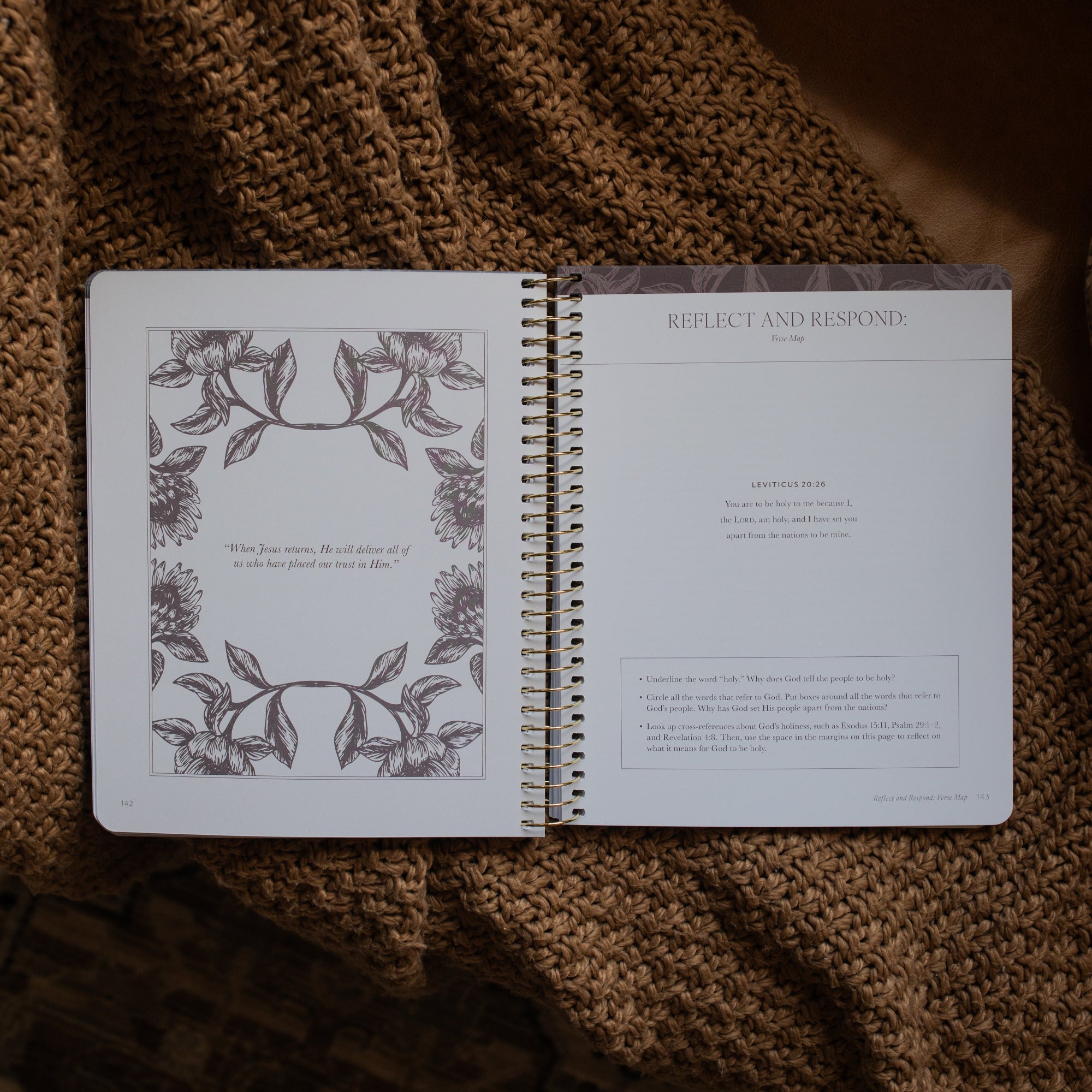 A Year in the Bible spiral opened to the Reflect and respond page on a brown knitted blanket