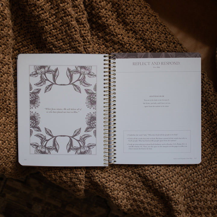 A Year in the Bible spiral opened to the Reflect and respond page on a brown knitted blanket