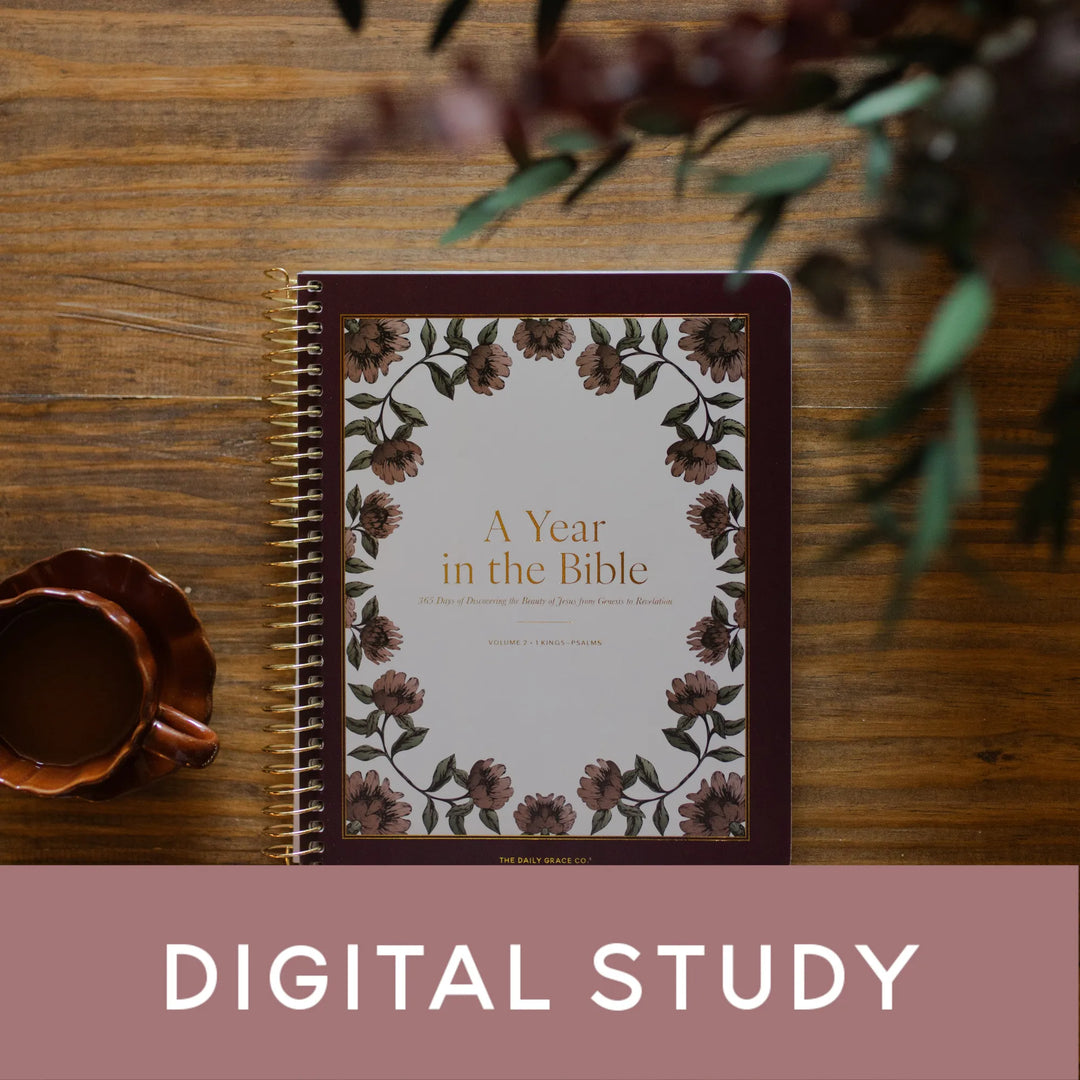 A Year in the Bible Spiral next to a brown coffee cup on a brown wooden table with a banner saying Digital Study